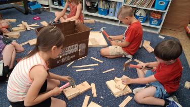 students hammering nails into wood