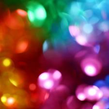 Artfully blurred close-up image of multi-coloured lights